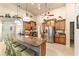 Open-concept kitchen featuring granite countertops, a stainless-steel refrigerator, and bar seating at 5005 Se 47Th Terrace Rd, Ocala, FL 34480