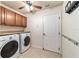 Clean and tidy laundry room with washer, dryer, storage cabinets and hanging rack at 5005 Se 47Th Terrace Rd, Ocala, FL 34480