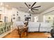 Cozy living room features hardwood floors, a ceiling fan, a TV and comfortable seating at 5005 Se 47Th Terrace Rd, Ocala, FL 34480