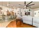Open-concept living room with bar seating, hardwood floors, bright light, and a view to the kitchen at 5005 Se 47Th Terrace Rd, Ocala, FL 34480