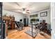 Spacious home office with two desk areas, ceiling fan, and wood flooring at 5005 Se 47Th Terrace Rd, Ocala, FL 34480