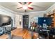Home office with built-in shelving, hardwood floors, and modern computer equipment at 5005 Se 47Th Terrace Rd, Ocala, FL 34480