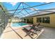 Spectacular screened pool and patio area with multiple lounge chairs overlooking the spacious backyard at 5005 Se 47Th Terrace Rd, Ocala, FL 34480
