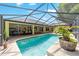 Gorgeous screened pool area with waterfall, covered patio, and manicured landscaping for ultimate outdoor living at 5005 Se 47Th Terrace Rd, Ocala, FL 34480