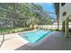 Stunning screened pool area with lush tropical plants and grass and featuring an attached patio area at 5005 Se 47Th Terrace Rd, Ocala, FL 34480