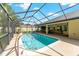 Backyard oasis with a sparkling pool inside of a screened in porch, along with an outdoor entertaining area at 5005 Se 47Th Terrace Rd, Ocala, FL 34480