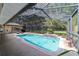 Enjoy the refreshing pool, enclosed in a screened lanai with a tropical landscaped waterfall feature at 5005 Se 47Th Terrace Rd, Ocala, FL 34480
