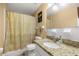 Bathroom with granite vanity, white ceramic tile, and shower with curtain at 680 Nw 67Th Pl, Ocala, FL 34475