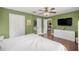 Bedroom with hardwood floors, a ceiling fan, and a large closet at 680 Nw 67Th Pl, Ocala, FL 34475