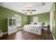 Bright bedroom with hardwood floors, a ceiling fan, and dual-paned windows at 680 Nw 67Th Pl, Ocala, FL 34475