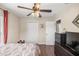 Comfortable bedroom with ceiling fan, closet, and dark wood floors at 680 Nw 67Th Pl, Ocala, FL 34475