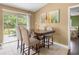 Dining area with high-top table, seating, and sliding glass doors to outdoor patio at 680 Nw 67Th Pl, Ocala, FL 34475