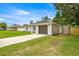 Exterior front view of home with lawn, driveway, and storage shed at 680 Nw 67Th Pl, Ocala, FL 34475