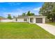 Cozy single-story home with an attached garage, front lawn, and simple landscaping at 680 Nw 67Th Pl, Ocala, FL 34475