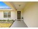 Inviting front porch with a charming front door, potted plants, and a window view at 680 Nw 67Th Pl, Ocala, FL 34475