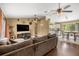 Comfortable living room with hardwood floors that flows into the adjacent kitchen and dining area at 680 Nw 67Th Pl, Ocala, FL 34475