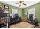 Bright home office with two desks and an overhead ceiling fan at 680 Nw 67Th Pl, Ocala, FL 34475