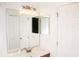 Bright bathroom featuring a large mirror, updated lighting fixtures, and a pristine white vanity at 2233 Ardon Ave, Orlando, FL 32833