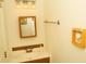 Bathroom featuring a sink, decorative nautical accessories, and a framed mirror at 2233 Ardon Ave, Orlando, FL 32833