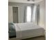 Bright bedroom featuring a white bed, closet, and sunlit window with curtains at 2233 Ardon Ave, Orlando, FL 32833