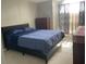 Comfortable bedroom featuring a bed with blue bedding, chest of drawers, and curtained window at 2233 Ardon Ave, Orlando, FL 32833