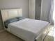 Bright bedroom featuring a white bed, closet, and sunlit window with curtain at 2233 Ardon Ave, Orlando, FL 32833