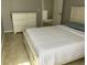 Bright bedroom featuring a white bed, closet, and access to other rooms at 2233 Ardon Ave, Orlando, FL 32833