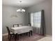 The dining room has a table, chairs, bench, and decorative chandelier at 2233 Ardon Ave, Orlando, FL 32833