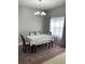 This dining room includes a table, chairs, bench and decorative chandelier at 2233 Ardon Ave, Orlando, FL 32833