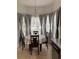 Eat-in kitchen area is enhanced by a large bay window, tile floors, and modern decor at 2233 Ardon Ave, Orlando, FL 32833