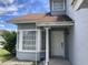 Charming front entry featuring a white door, trimmed windows, and column at 2233 Ardon Ave, Orlando, FL 32833