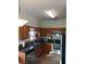 A kitchen featuring wooden cabinets, stainless steel appliances, and tile flooring at 2233 Ardon Ave, Orlando, FL 32833