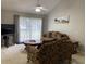 A living room with a ceiling fan, seating, and a sliding glass door at 2233 Ardon Ave, Orlando, FL 32833