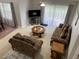 The living room offers comfortable seating, a ceiling fan, and sliding glass doors at 2233 Ardon Ave, Orlando, FL 32833