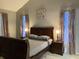 Main bedroom with a large bed, two nightstands, and art on the wall at 2233 Ardon Ave, Orlando, FL 32833