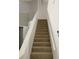 Carpeted stairway leading to the upper level of the home, with white walls and trim at 2233 Ardon Ave, Orlando, FL 32833