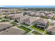 Aerial view of a residential neighborhood showcasing well-maintained homes and landscaping at 6612 Tempo Way, Groveland, FL 34736
