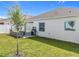 Exterior backyard view with grill, patio, and well maintained landscaping at 6612 Tempo Way, Groveland, FL 34736