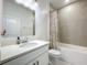 Clean bathroom featuring a vanity with quartz countertop and a shower/tub with tile surround at 6612 Tempo Way, Groveland, FL 34736