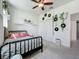 Cozy bedroom with a black wrought iron bed, decorative records and plant accents at 6612 Tempo Way, Groveland, FL 34736
