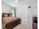 Comfortable bedroom with a dark wood bed frame and closet, offering a peaceful retreat at 6612 Tempo Way, Groveland, FL 34736