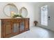 Inviting foyer features white marble flooring, decorative glass front door, and an ornate wooden console table at 6612 Tempo Way, Groveland, FL 34736