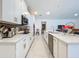 Modern kitchen featuring white cabinets, quartz countertops, stainless steel appliances, and a large island at 6612 Tempo Way, Groveland, FL 34736