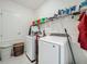 Well-organized laundry room with modern washer and dryer and plenty of storage at 6612 Tempo Way, Groveland, FL 34736