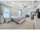 Spacious main bedroom with tray ceiling, fan, and lots of natural light at 6612 Tempo Way, Groveland, FL 34736