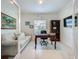 Well-lit home office with a desk, bookcase, sofa, and a large window at 6612 Tempo Way, Groveland, FL 34736