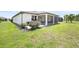 Manicured backyard of a beautiful home showcasing a screened lanai at 9478 Sw 52Nd Loop, Ocala, FL 34481