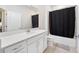 Bathroom with a quartz countertop vanity and shower with a tub at 9478 Sw 52Nd Loop, Ocala, FL 34481