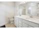 Bright bathroom featuring double sinks, white cabinets, and modern fixtures at 9478 Sw 52Nd Loop, Ocala, FL 34481