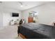 Cozy bedroom with a plush bed, large window, and elegant furnishings at 9478 Sw 52Nd Loop, Ocala, FL 34481